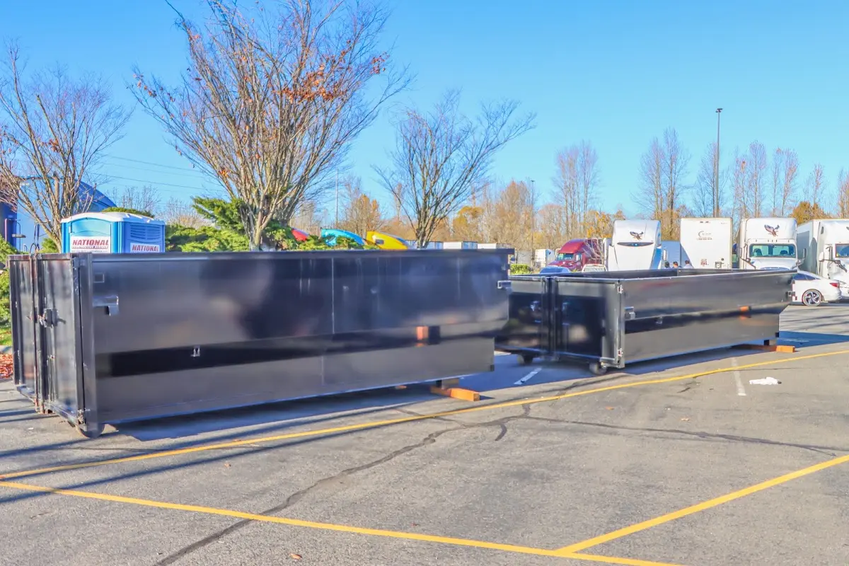 Professional dumpster rental service with roll-off container on residential driveway in Branson